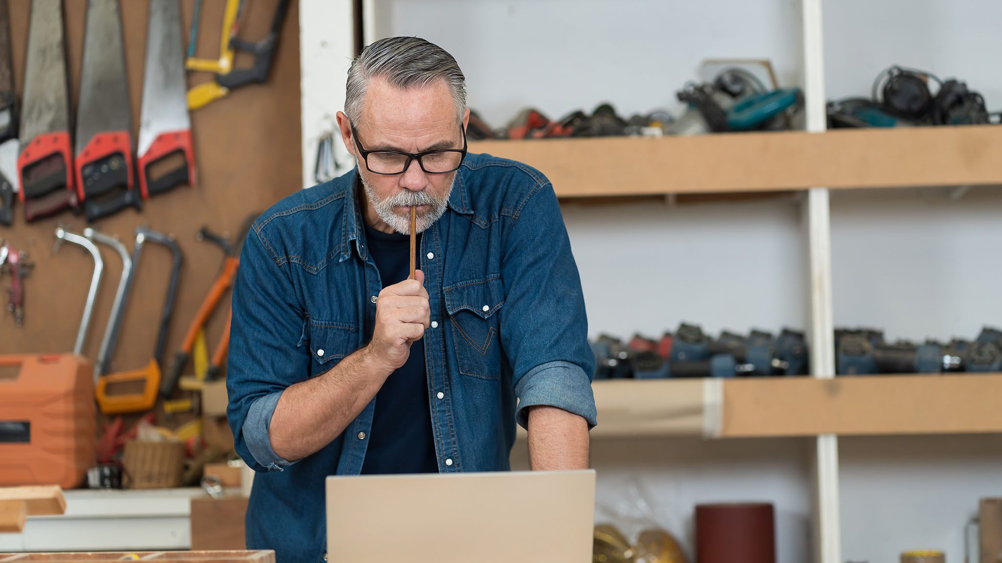 Professional Senior Male Carpenter Using Using Laptop Computer W Professional Senior Male Carpenter Using Using Laptop Computer W